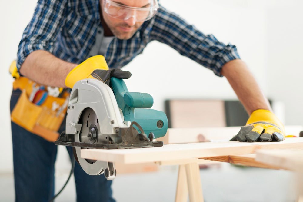 carpenter working with circular saw Siding Company near me Siding Company near me,siding services,siding experts in nj